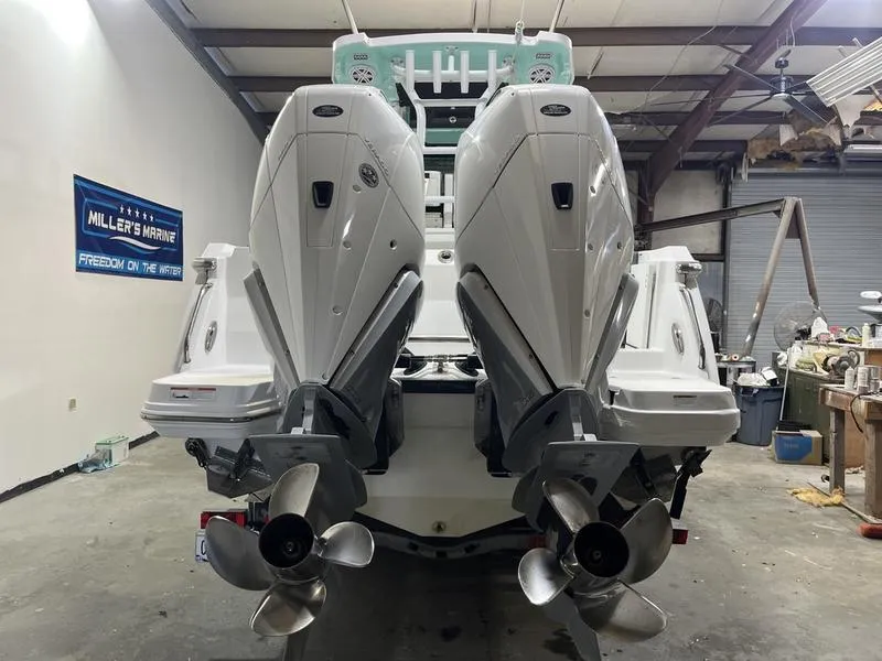 Slide: The Image of 2019 Blackfin 272 CC boat with dual outboard engines in a garage setting. - 5