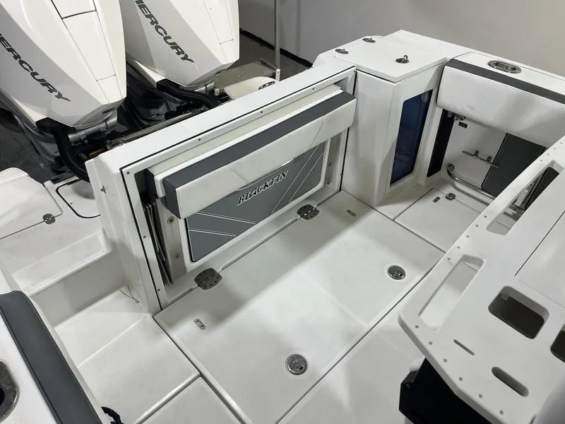 Slide: The Image of 2019 Blackfin 272 CC boat deck with storage and dual Mercury engines. - 8