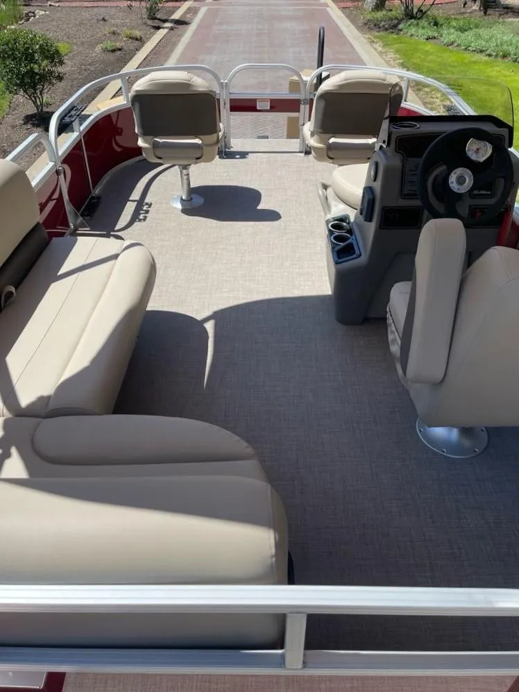Slide: The Image of 2025 Sun Tracker Bass Buggy 16 XL Select pontoon boat interior with beige seating and steering console. - 6