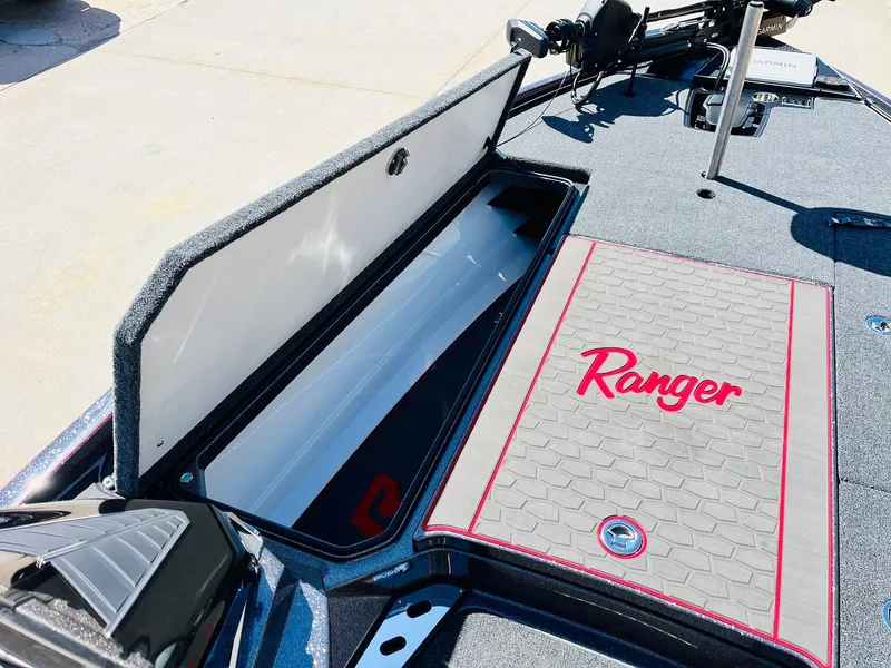 Slide: The Image of 2025 Ranger Z521R Cup-Equipped boat with open storage compartment and branded deck mat. - 15
