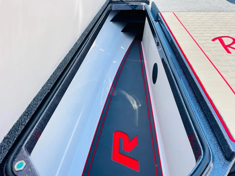 Slide: The Image of 2025 Ranger Z521R Cup-Equipped boat storage compartment with sleek design and red accents. - 16