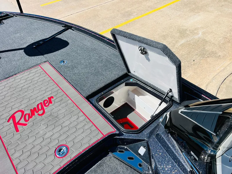 Slide: The Image of 2025 Ranger Z521R Cup-Equipped boat with open storage compartment and branded deck. - 21