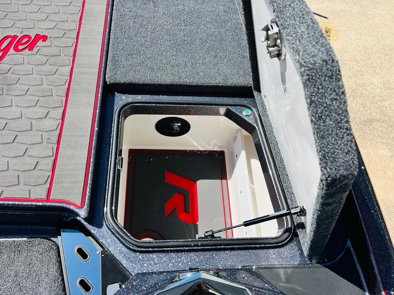 Slide: The Image of 2025 Ranger Z521R Cup-Equipped boat storage compartment with open lid and logo detail. - 22