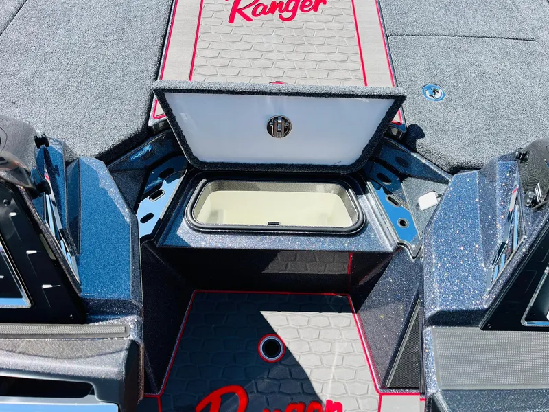 Slide: The Image of 2025 Ranger Z521R Cup-Equipped boat interior with open storage compartment and branded flooring. - 24