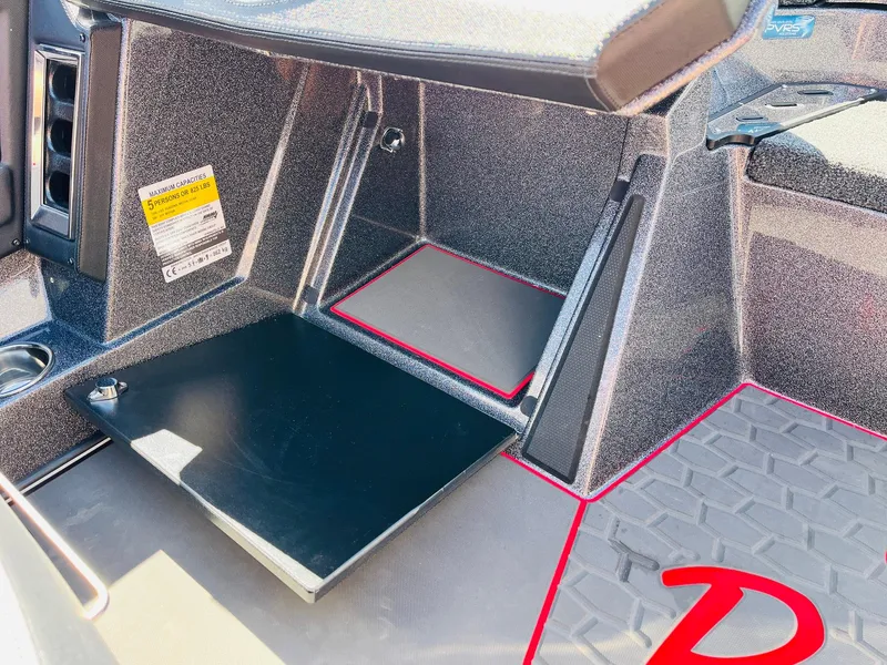 Slide: The Image of 2025 Ranger Z521R Cup-Equipped interior with storage compartment and red accents. - 35