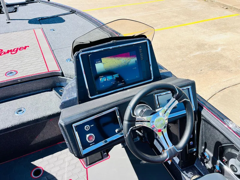 Slide: The Image of 2025 Ranger Z521R Cup-Equipped boat dashboard with steering wheel and digital display. - 37