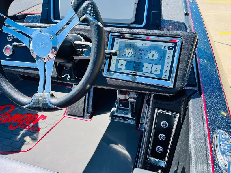 Slide: The Image of 2025 Ranger Z521R Cup-Equipped boat dashboard with touchscreen and steering wheel. - 45