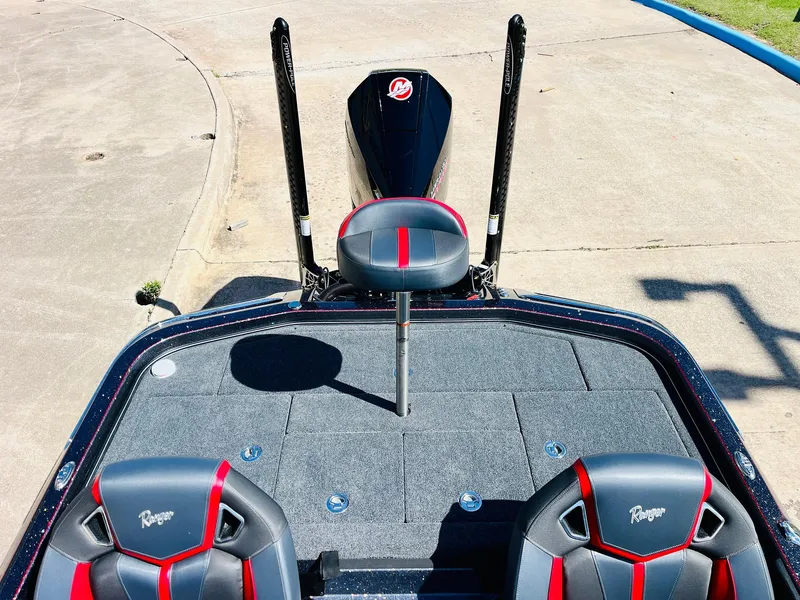 Slide: The Image of 2025 Ranger Z521R Cup-Equipped boat interior with red and gray seating, viewed from above. - 46