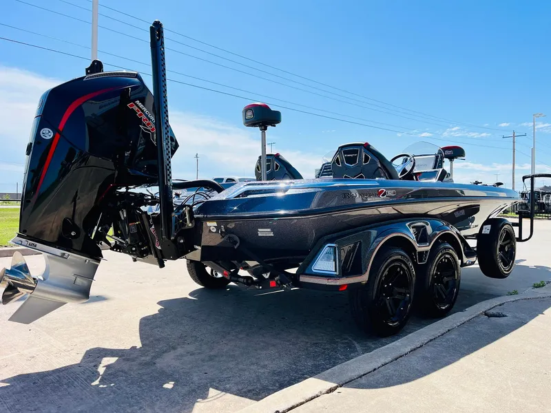 Slide: The Image of 2025 Ranger Z521R Cup-Equipped boat with powerful outboard motor, parked on concrete under clear sky. - 5