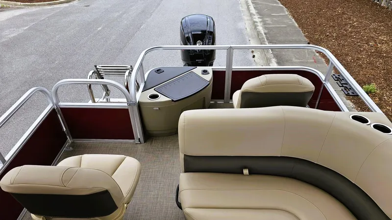 Slide: The Image of 2025 Sun Tracker Bass Buggy 18 DLX pontoon boat interior with seating and motor. - 11