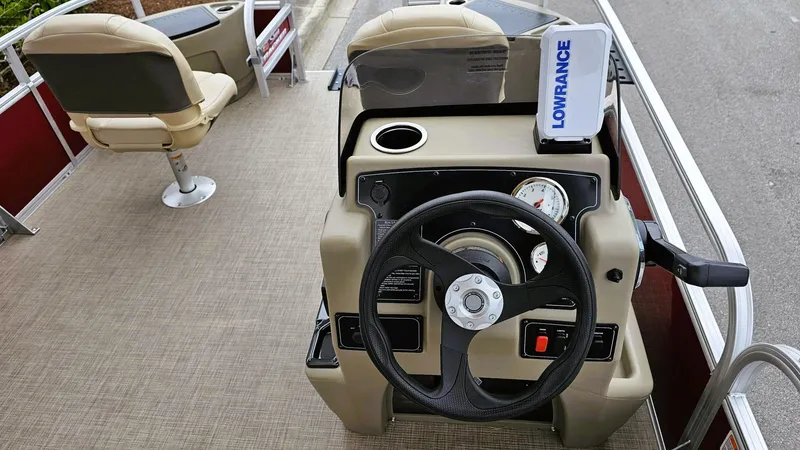 Slide: The Image of 2025 Sun Tracker Bass Buggy 18 DLX boat interior with steering wheel and Lowrance device. - 9
