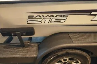 Slide: The Image of 2025 Tracker Savage 215 boat trailer with logo and tire detail. - 3