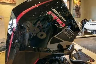 Slide: The Image of 2025 Tracker Savage 215 with Mercury Pro XS engine in showroom display. - 5
