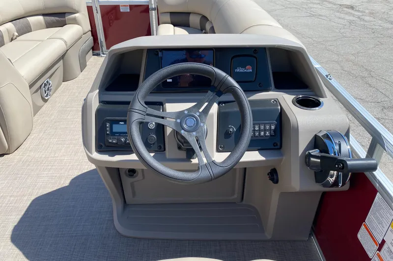 Slide: The Image of 2025 Sun Tracker Party Barge 20 DLX helm with steering wheel and control panel. - 2