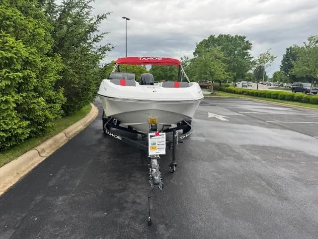 Slide: The Image of 2025 Tahoe T16 boat with red canopy on a trailer in a parking lot. - 2