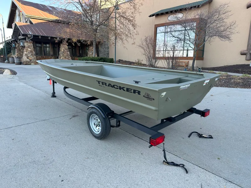 Slide: The Image of 2025 Tracker Grizzly 1648 Jon boat on trailer, parked outdoors. - 2