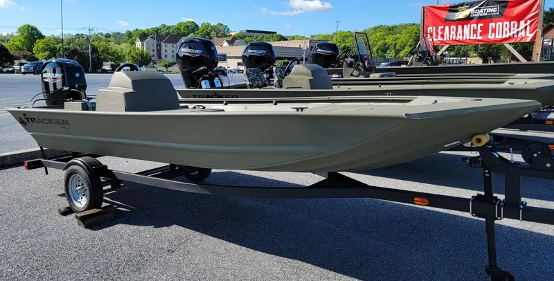 Slide: The Image of 2025 Tracker Grizzly 1648 SC boat on trailer, displayed outdoors with clearance sale banner. - 3