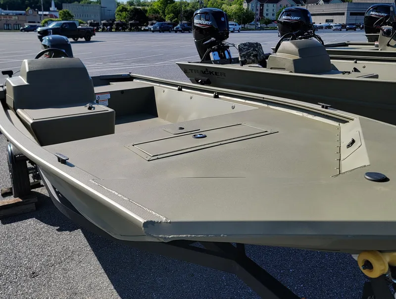 Slide: The Image of 2025 Tracker Grizzly 1648 SC boat in a parking lot, featuring dual outboard motors. - 5