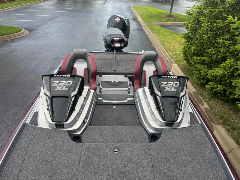 Slide: The Image of 2025 Nitro Z20 XL Pro boat with dual seats and sleek design in a parking lot. - 4