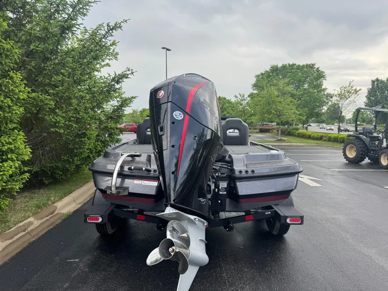 Slide: The Image of 2025 Nitro Z20 XL Pro boat with powerful outboard motor in a parking lot. - 5