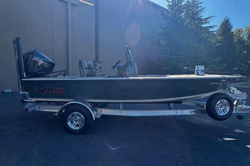 Slide: The Image of 2025 Mako 18 Pro Skiff Backwater Edition boat on trailer, outdoor setting. - 6