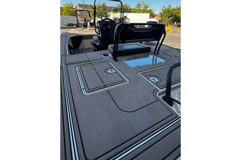 Slide: The Image of 2025 Mako 18 Pro Skiff Backwater Edition boat deck with storage compartments. - 7