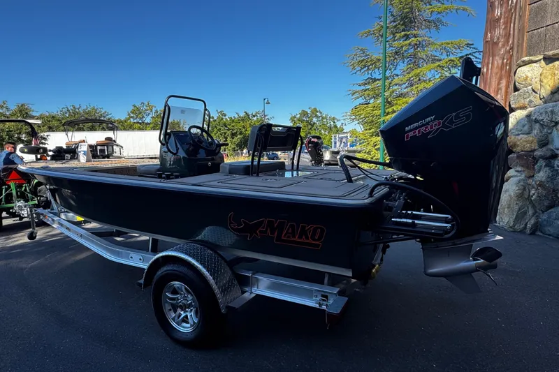 Slide: The Image of 2025 Mako 18 Pro Skiff Backwater Edition boat on trailer, outdoors. - 3