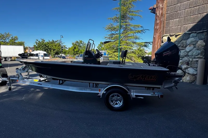 The Image of 2025 Mako 18 Pro Skiff Backwater Edition boat on trailer, parked outdoors. - 0