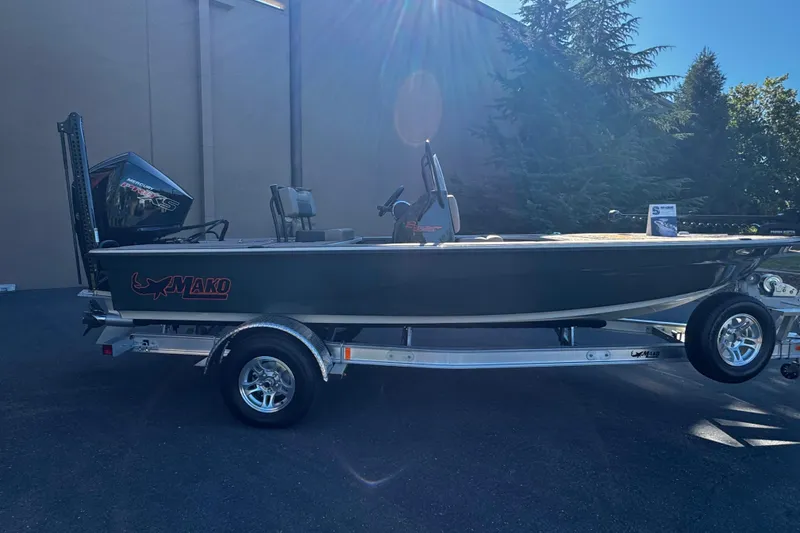 Slide: The Image of 2025 Mako 18 Pro Skiff Backwater Edition boat on trailer, outdoor setting. - 5