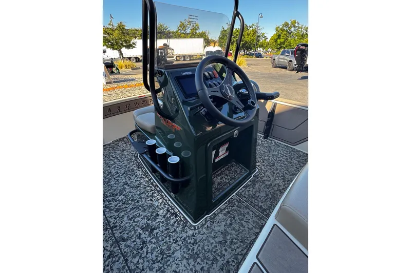 Slide: The Image of 2025 Mako 18 Pro Skiff Backwater Edition boat console with steering wheel and controls. - 8