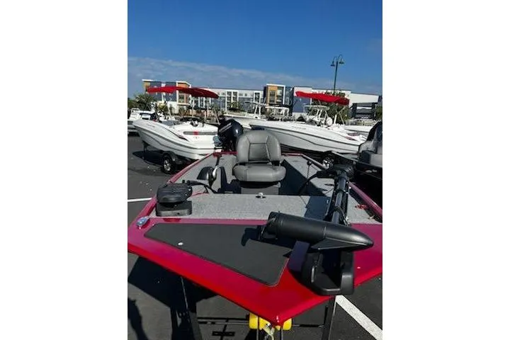 Slide: The Image of 2025 Tracker Panfish 17 boat in a parking lot, featuring a red exterior and gray seating. - 3