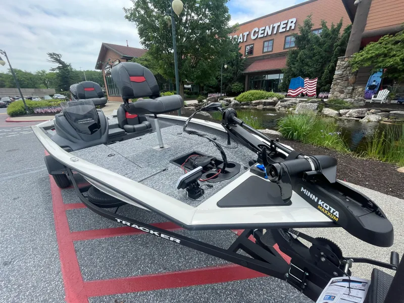 Slide: The Image of 2025 Tracker Pro Team 175 boat displayed outside a boat center. - 2