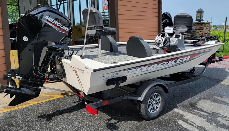 Slide: The Image of 2025 Tracker Pro Team 175 boat with Mercury engine on trailer, parked outdoors. - 5