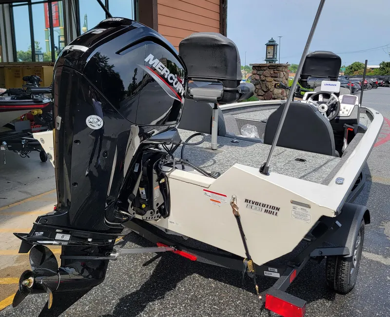 Slide: The Image of 2025 Tracker Pro Team 175 boat with Mercury engine, parked outdoors. - 7