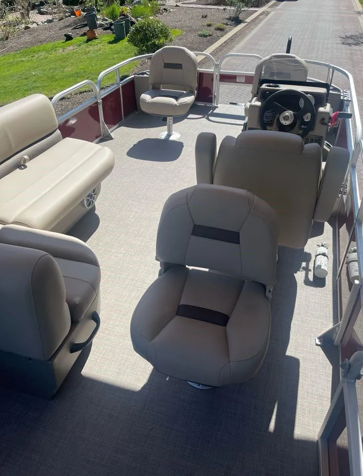 Slide: The Image of 2025 Sun Tracker Bass Buggy 18 DLX pontoon boat interior with beige seating. - 5