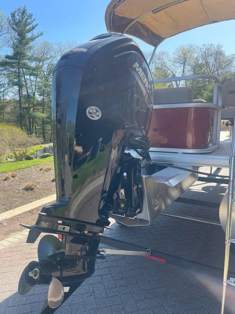 Slide: The Image of 2025 Sun Tracker Bass Buggy 18 DLX pontoon boat with Mercury outboard motor. - 6