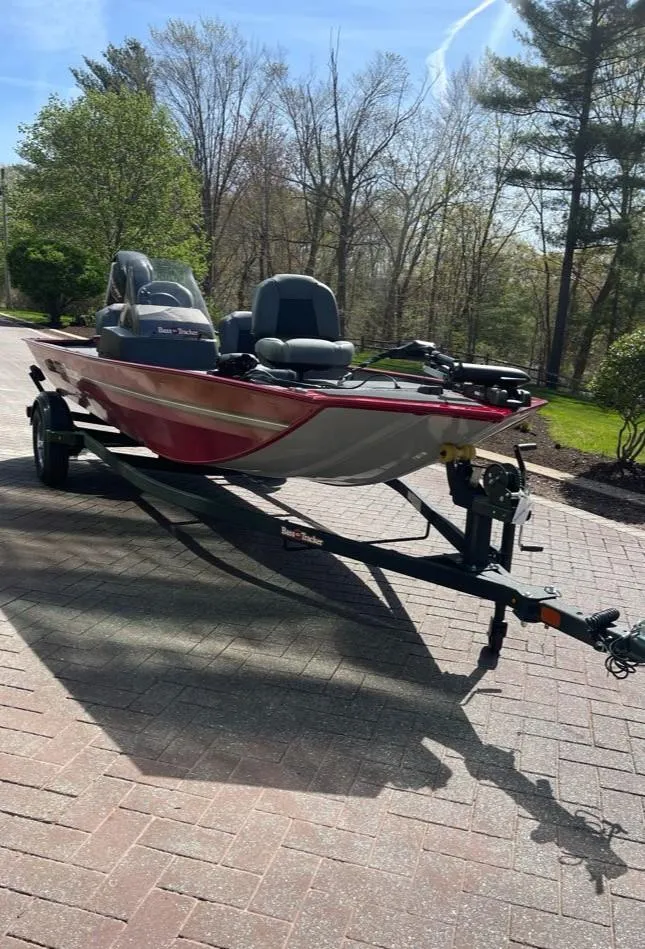 Slide: The Image of 2025 Tracker Bass Tracker Classic XL boat on trailer, parked on a sunny driveway. - 2