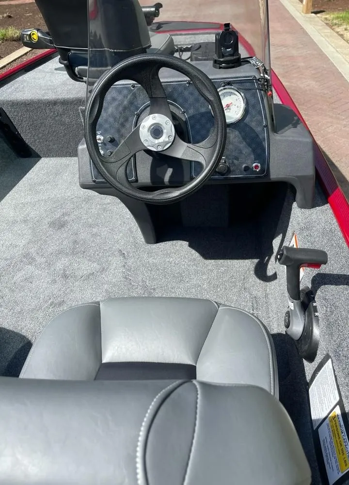 Slide: The Image of 2025 Tracker Bass Tracker Classic XL boat interior with steering wheel and seat. - 4