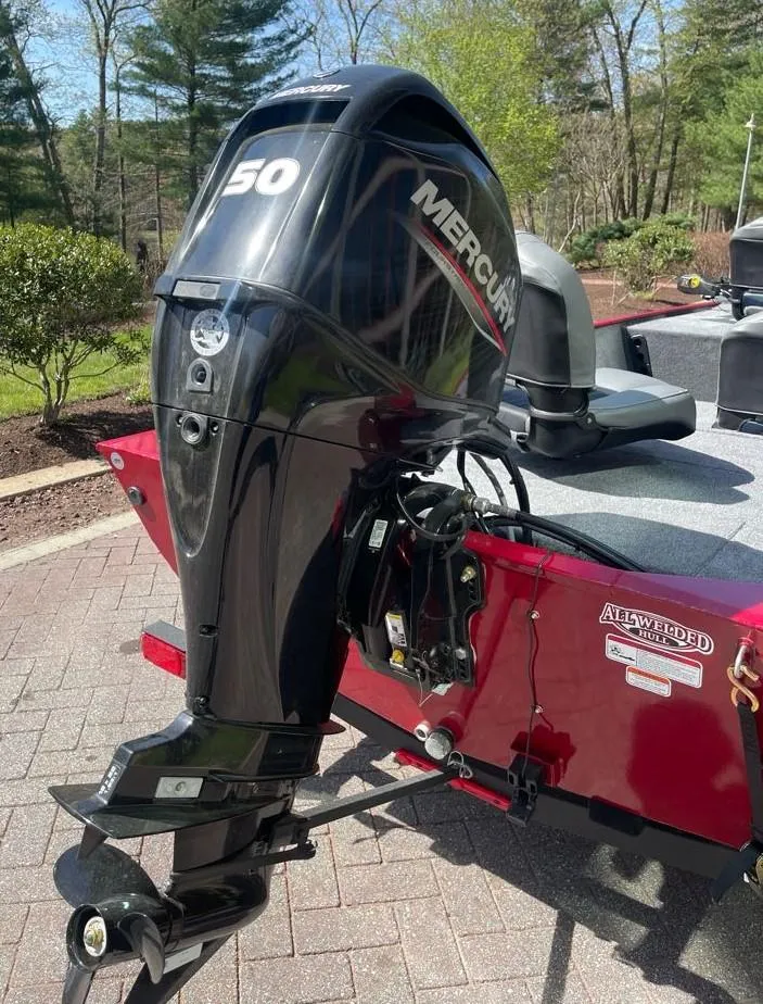 Slide: The Image of 2025 Tracker Bass Tracker Classic XL with Mercury 50 outboard motor, parked on a paved driveway. - 7