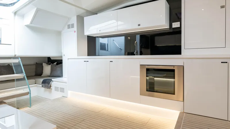 Slide: The Image of Luxurious interior of 2024 VanDutch 56 yacht with modern kitchen and seating area. - 13