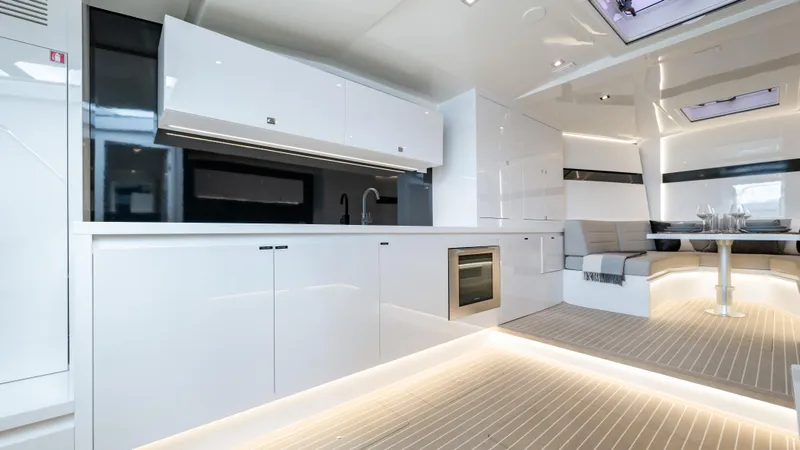 Slide: The Image of Luxurious interior of 2024 VanDutch 56 yacht with modern kitchen and seating area. - 14