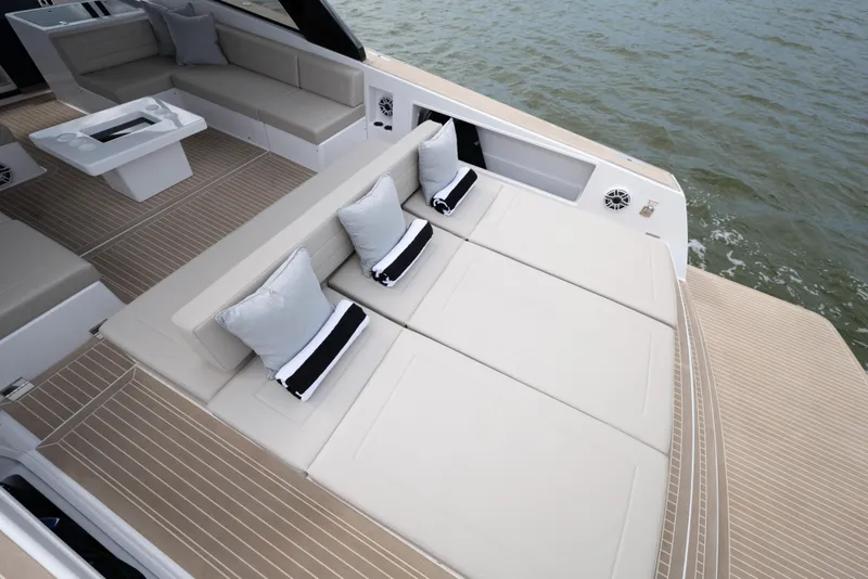 Slide: The Image of Luxurious 2024 VanDutch 56 yacht deck with elegant seating and cushions on the water. - 7