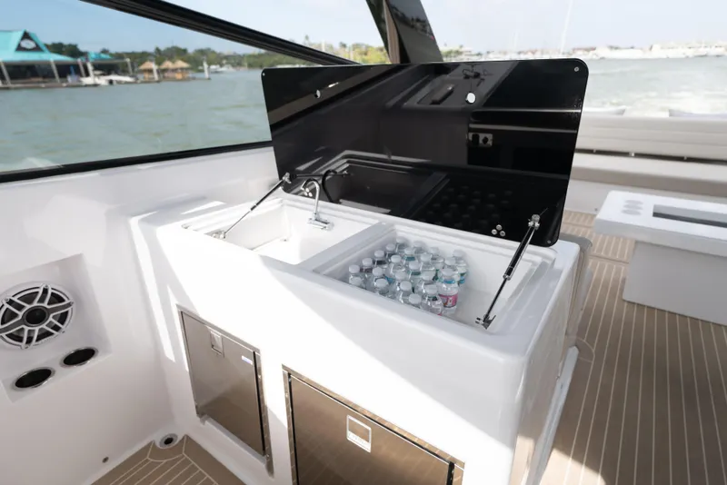 Slide: The Image of 2024 VanDutch 56 yacht interior with beverage cooler and storage compartments. - 9