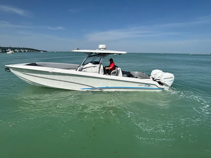The Image of 2018 Nor-Tech 340 Sport Center Console boat on turquoise water under clear blue sky. - 0