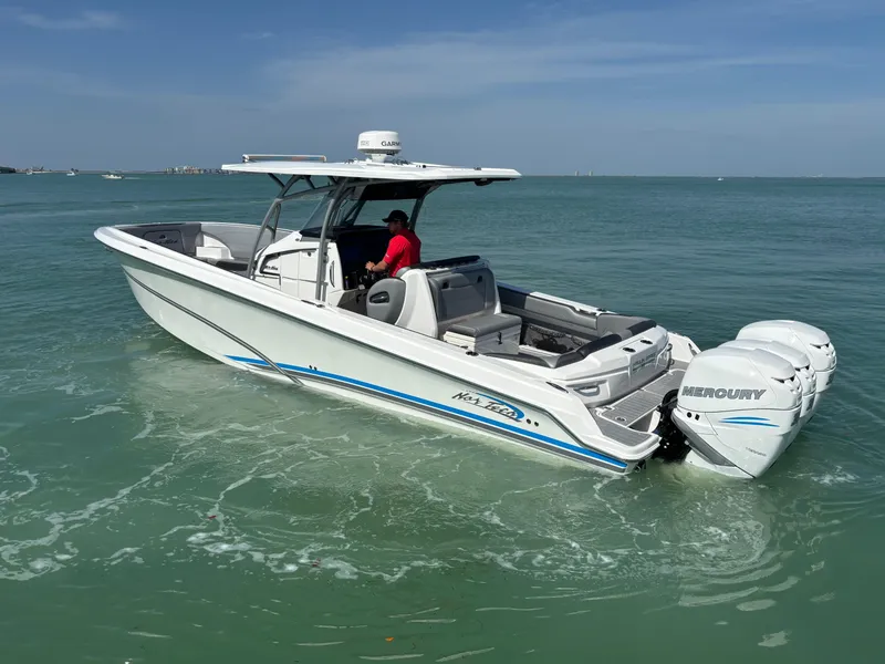 Slide: The Image of 2018 Nor-Tech 340 Sport Center Console boat cruising on open water. - 1