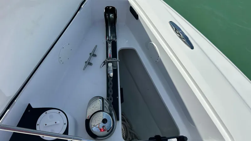 Slide: The Image of Anchor compartment of 2018 Nor-Tech 340 Sport Center Console boat, featuring anchor and chain. - 14