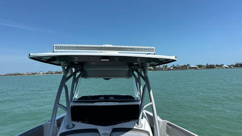 Slide: The Image of 2018 Nor-Tech 340 Sport Center Console on calm waters under clear blue sky. - 16