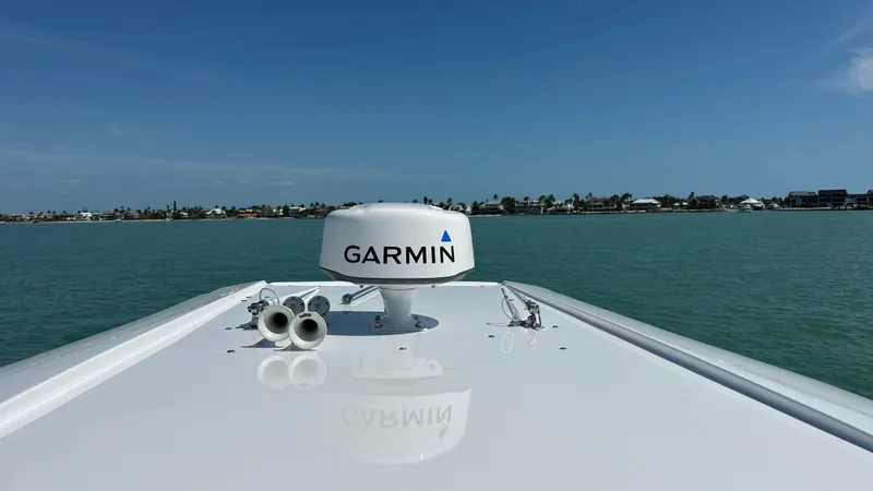 Slide: The Image of 2018 Nor-Tech 340 Sport Center Console with Garmin radar on calm waters. - 17