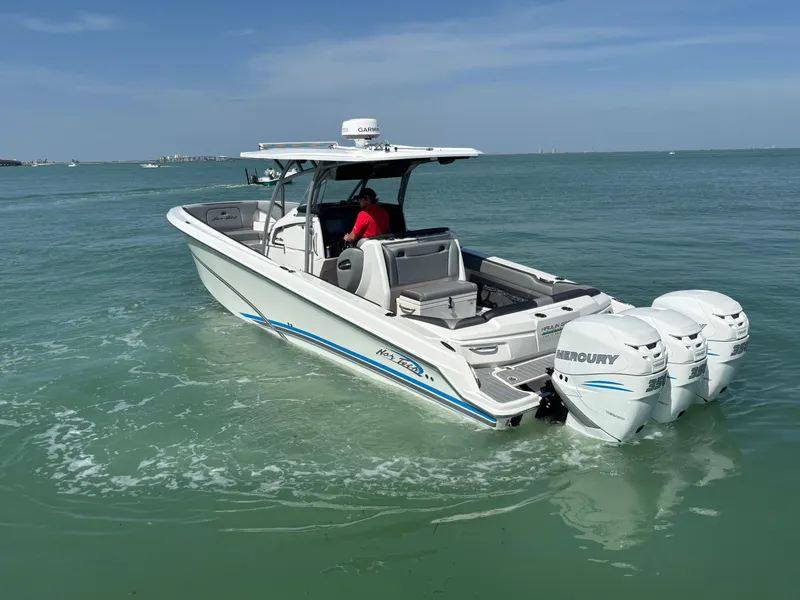 Slide: The Image of 2018 Nor-Tech 340 Sport Center Console boat cruising on open water. - 2