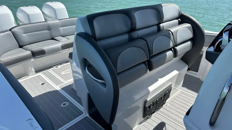 Slide: The Image of 2018 Nor-Tech 340 Sport Center Console interior with luxurious seating and sleek design. - 21